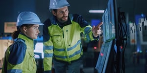 Drilling personnel reviewing real-time operational data in a drilling control room